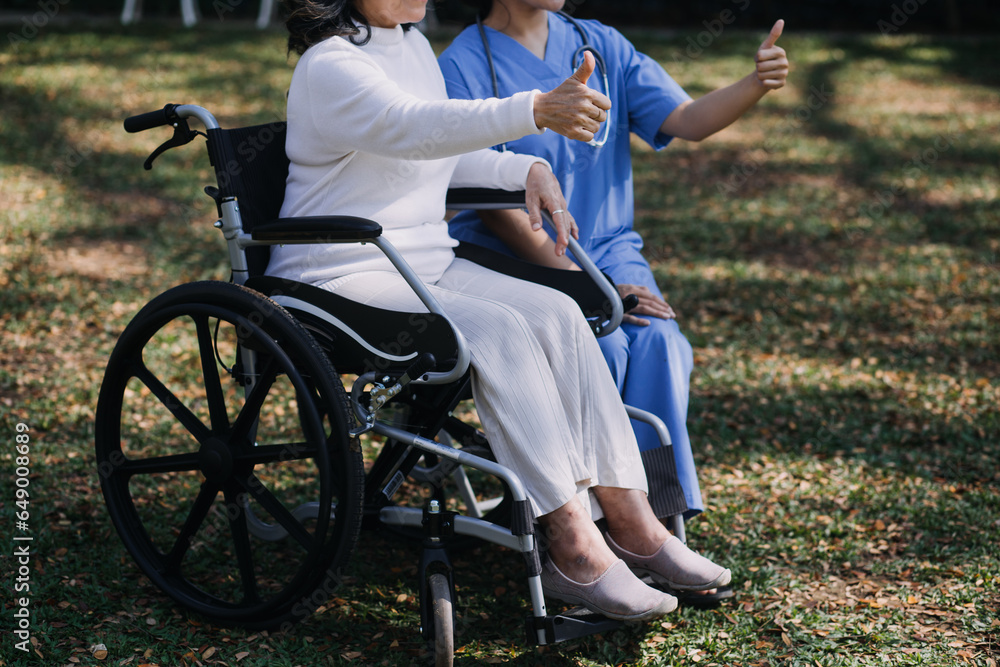 Fototapeta premium Asian young woman nurse at nursing home take care disabled senior man. Caregiver doctor serve physical therapy for older elderly patient to exercise and practice walking on walker or cane at backyard.