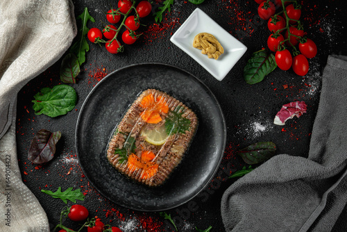 Obraz na płótnie Meat aspic in a dark plate with mustard