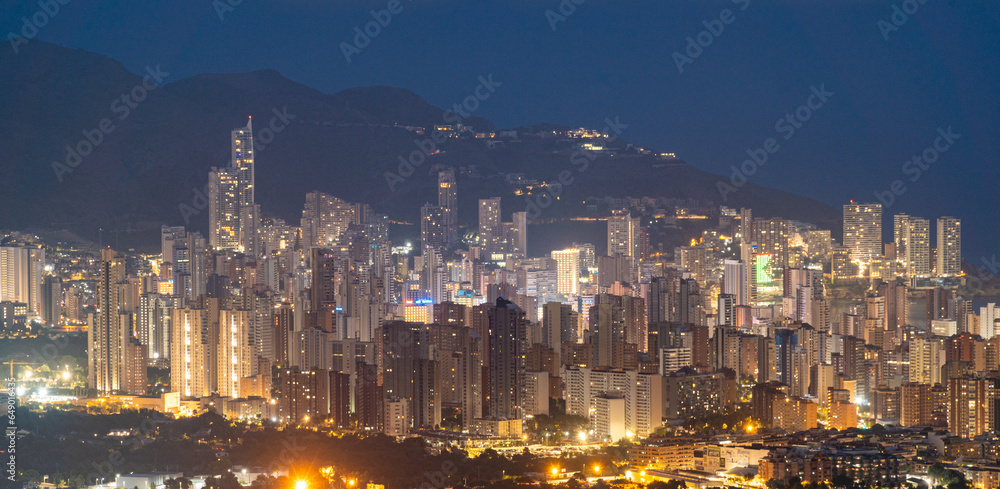 Obraz premium Benidorm skyline with skyscrapers at night.