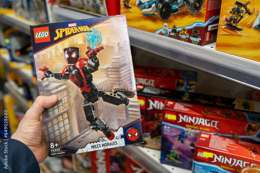 Naklejka premium Lego Spiderman constructor game. Buyer take box Lego Spider-Man from shelf in a Toys store. Minsk, Belarus, September 17, 2023