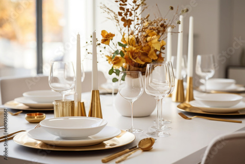 Autumn table setting. A sleek dining table adorned with colorful leaves, candles. Minimalist white and gold decor. Generative AI