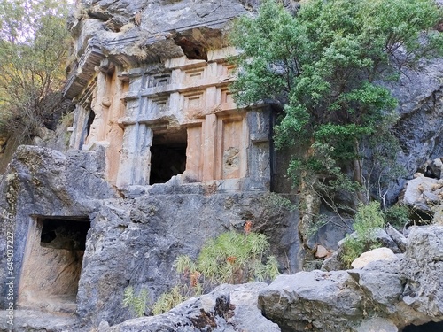 Pinara ruins of an ancient city near Fethiye, Mugla, Türkiye. Lycian tombs, ancient Roman amphitheater and mountains. photo
