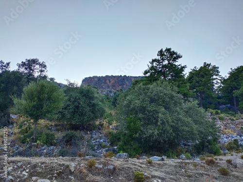 Pinara ruins of an ancient city near Fethiye, Mugla, Türkiye. Lycian tombs, ancient Roman amphitheater and mountains. photo