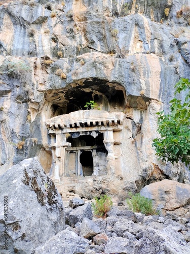 Pinara ruins of an ancient city near Fethiye, Mugla, Türkiye. Lycian tombs, ancient Roman amphitheater and mountains.