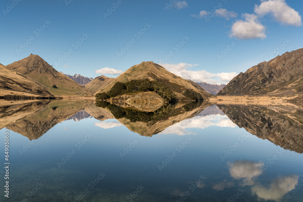 Reflections of the hills and cloudscape  on the remote Moke Lake near Queenstown  New Zealand
