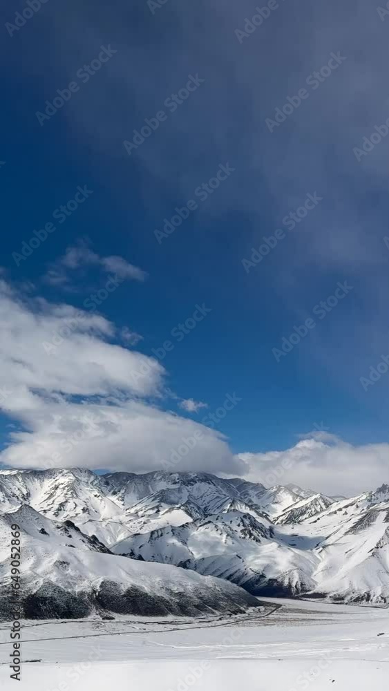 Vertical video of Aerial view drone flying over beautiful white snowy mountains Vertical video of Aerial view drone flying over beautiful white snowy mountains