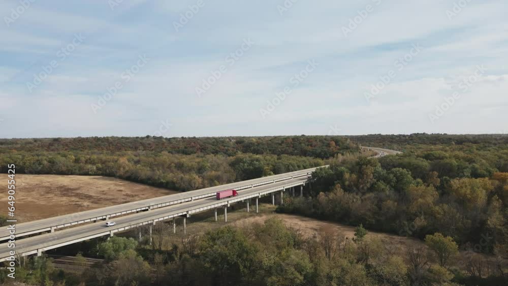 Aerial view of highway and railroad track. Large red truck moving on the highway bridge Aerial view of highway and railroad track. Large red truck moving on the highway bridge