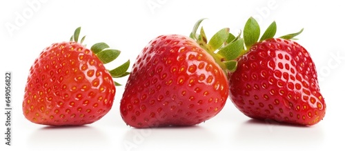 Close up of three fresh strawberries on a white background with copyspace for text
