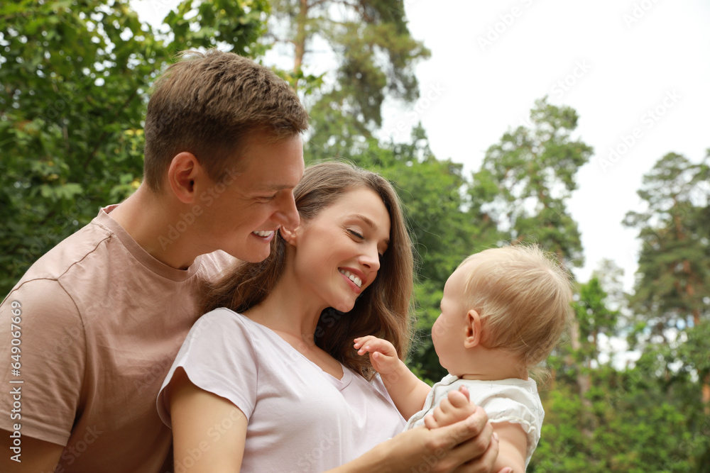 Parents with their cute baby spending time together outdoors. Happy family Parents with their cute baby spending time together outdoors. Happy family