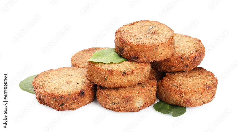 Delicious vegan cutlets and spinach on white background