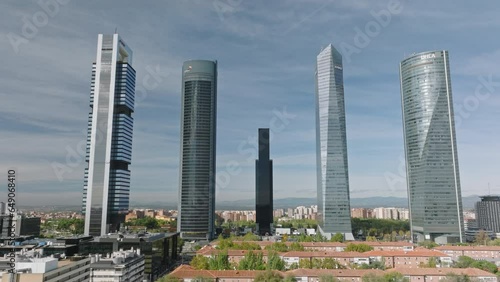 Soaring over Madrid's financial district unveils a dance of steel, glass, and economic dynamism.
 photo