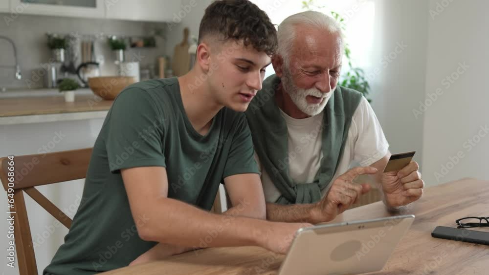 teenager and senior man grandfather use credit card shopping online teenager and senior man grandfather use credit card shopping online