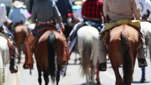 a group of mexican cowboys or charros on horseback, galloping at low speed, mexican culture