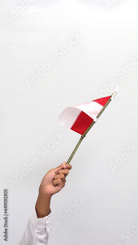 Han holding a small Indonesian flag, isolated on white background