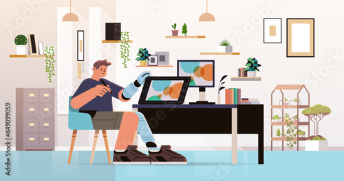 disabled man graphic designer with replaced robotic leg and arm guy working on laptop people with disabilities concept