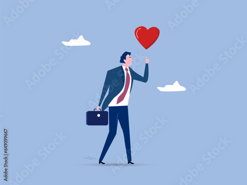 Happy businessman holding passionate heart shape walking to work.Work passion to motivate and inspire employee to achieve career success, love your job or happy and enjoy working dream job concept.