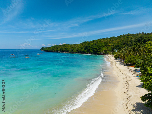 Fototapeta Naklejka Na Ścianę i Meble -  White sandy beach with turquoise sea water and waves. Samal Island. Davao, Philippines.