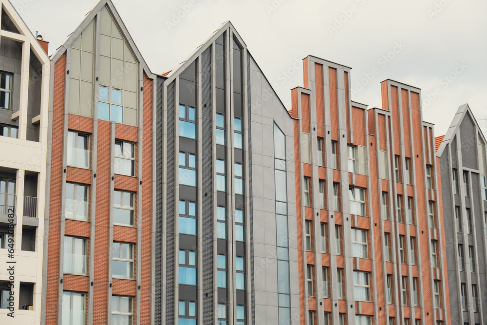 Modern office building exterior with glass facade on clear sky background. Transparent glass wall of office building with yellow decoration. Abstract Structure Element of facade of modern European Modern office building exterior with glass facade on clear sky background. Transparent glass wall of office building with yellow decoration. Abstract Structure Element of facade of modern European