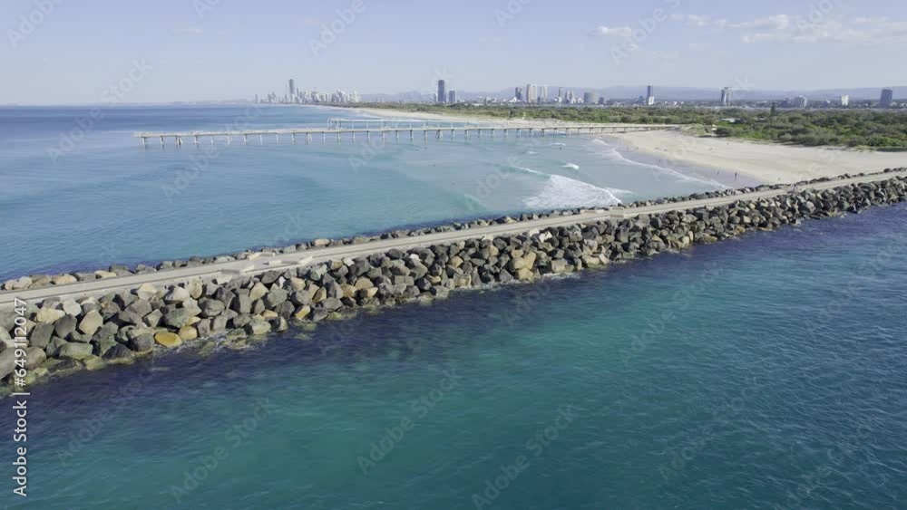 The Spit Seawall With Sand Bypass Pumping Jetty In The Distance - Main Beach, Australia. - aerial The Spit Seawall With Sand Bypass Pumping Jetty In The Distance - Main Beach, Australia. - aerial