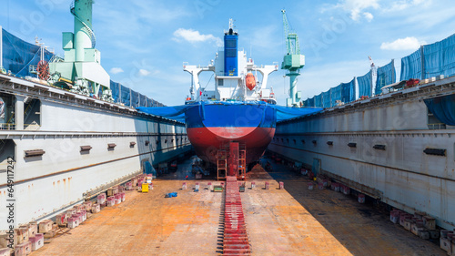 cargo container ship at dry dock concept maintenance service working in the sea. Insurance and Maintenance Cargo Ship concept. Freight Forwarding Service maintenance Insurance photo