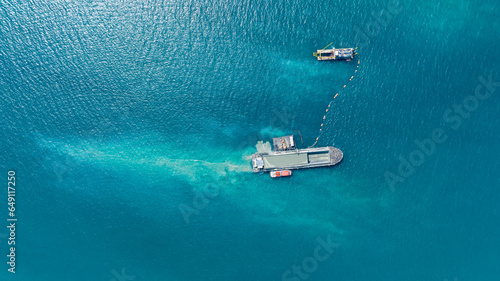 Photo Aerial top view of Vessel engaged in dredging