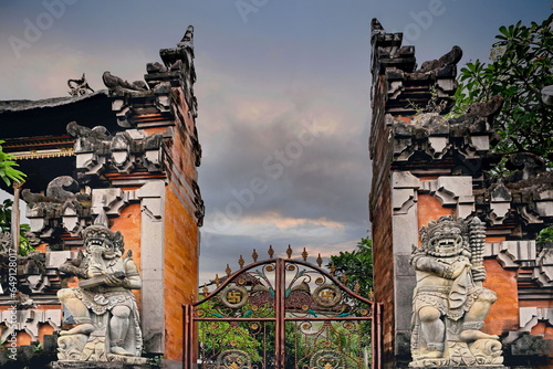 Entrance of a temle in Bali, with sculptures serve as gate guardians, with twin dvarapalas flanking entrances photo