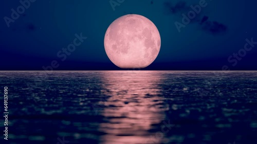 The moon slowly rises above the sea level.