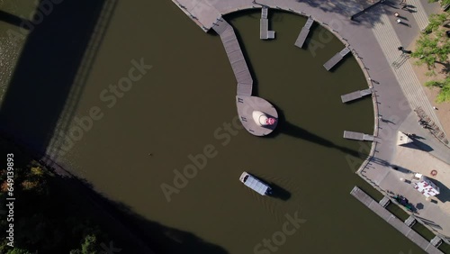 Overhead of a Water Taxi on the Red River, Passenger Boat passing docks, 4K aerial photo