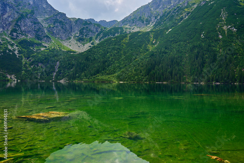Amazing view on mountains range near beautiful lake at summer day. Tatra National Park in Poland. Panoramic view on Morskie Oko or Sea Eye lake in Five lakes valley
