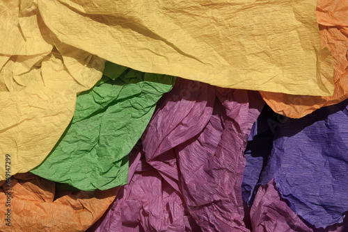 Crumpled paper in various colors in muted tones. Background, retro, texture, light and shadow.