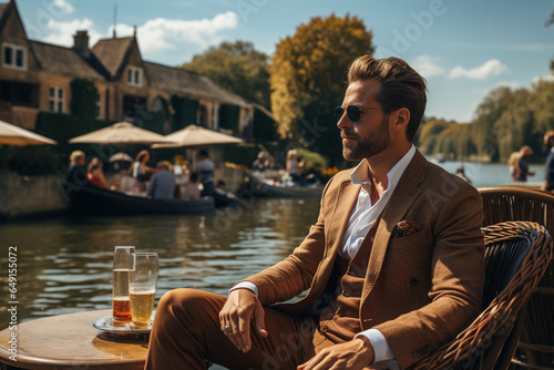 photo of the guy by a picturesque riverside location, dressed in vintage fashion, epitomizing the old money lifestyle of leisure and luxury by the water photo