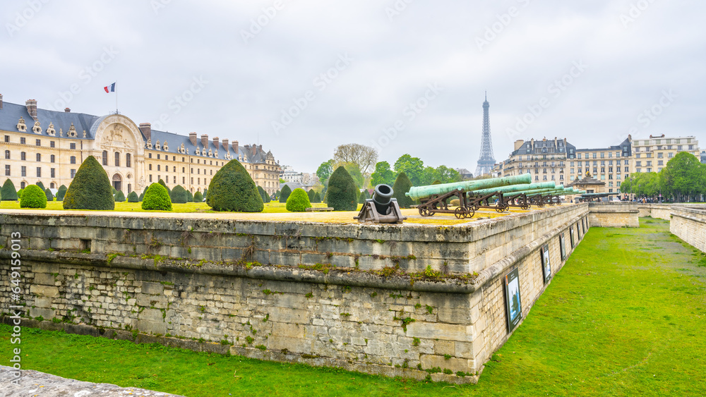 Historical cannons at Les Invalides and parisian cityscape with Eiffel Tower, Paris, France