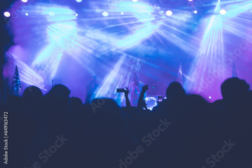 Abstract photo of crowd at concert and blurred stage lights. © erika8213