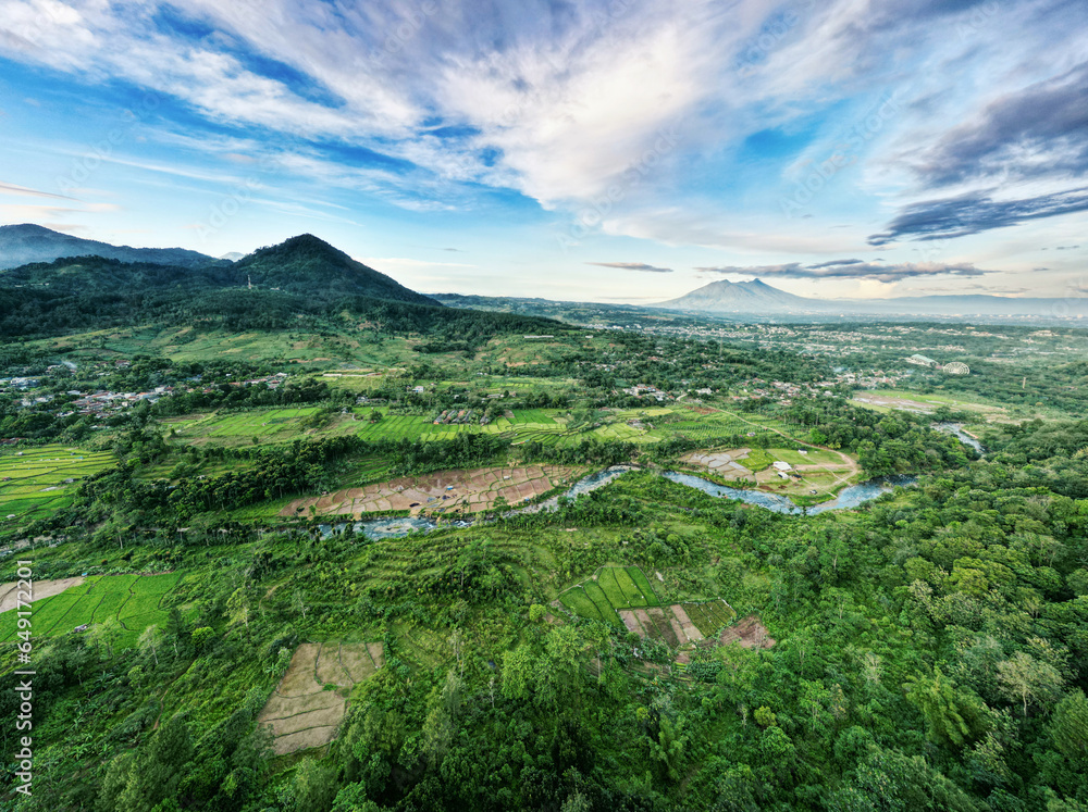 Obraz premium Aerial drone view of a small town in high mountains with thin fogs