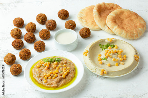 Middle eastern Arab breakfast of hummus, mashed beans plate, and falafel. photo