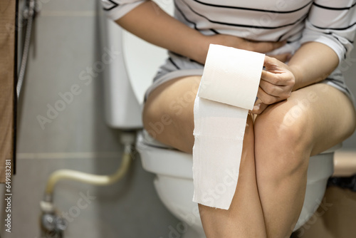 Asian woman suffering from acute cystitis,inflammation,bladder infection,urinary retention,problem of urinary stone,urinary hesitancy,frequent painful or difficult urination,presence of blood in urine photo