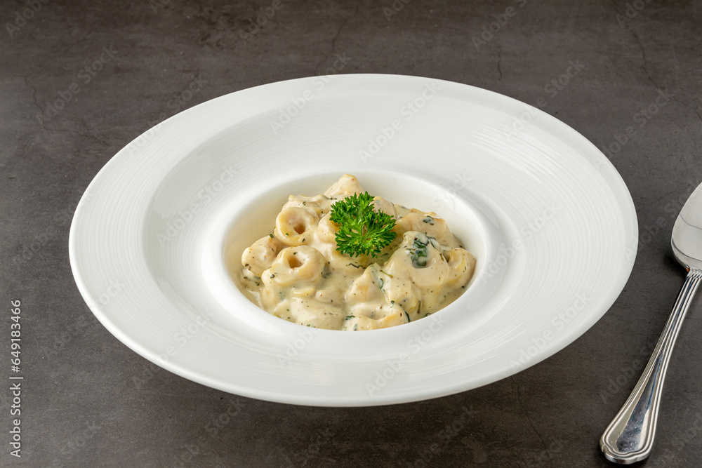 Delicious italian food tortellini pasta with mushroom cream sauce and cheese Delicious italian food tortellini pasta with mushroom cream sauce and cheese
