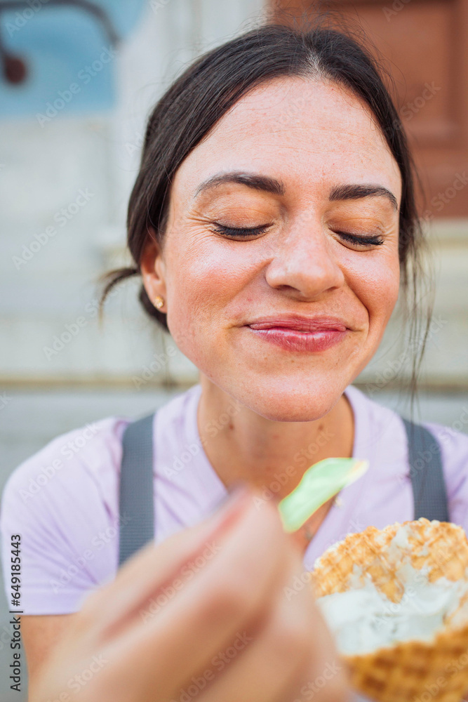 Smiling young woman having ice cream cone Smiling young woman having ice cream cone