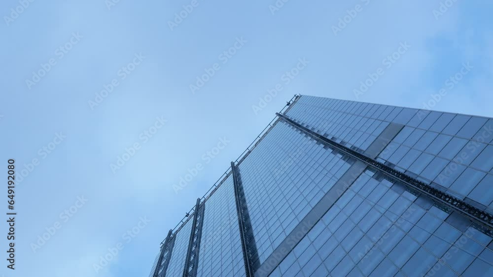 Modern office high rise skyscraper financial buildings in city business district center. Looking up at modern glasses buildings up to sky with clear blue sky