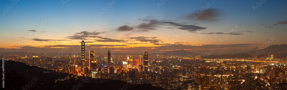 Urban Splendor at Night: Watching Dynamic Clouds Above a Dazzling Cityscape. View of Taipei city from the Four Beasts Mountain Trail, Taiwan