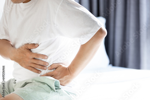 Middle aged man with left abdominal pain,uncomfortable tightness in the abdomen,stomach ache,soreness in belly and difficulty breathing,symptoms of splenomegaly,abnormal enlargement of the spleen photo