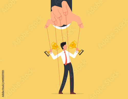 Domination or manipulate by control puppet doll, marionette or exploitation. Businessman marionette on ropes controlled hand.