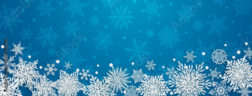 Christmas illustration with beautiful complex paper snowflakes, white on blue background