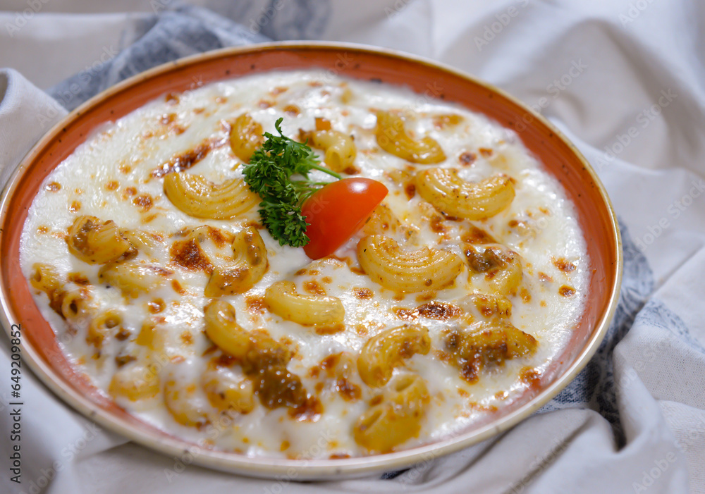 Macaroni Bechamel with tomato served in dish isolated on food table top view of middle east spices Macaroni Bechamel with tomato served in dish isolated on food table top view of middle east spices