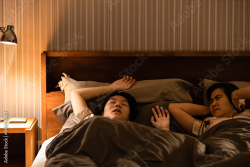 Asian teenage girl snoring in bed having chronic nasal congestion,symptom of obstructive sleep apnea,making a snorting or grunting sound while asleep,sleep disorder,health issues,health care concept photo