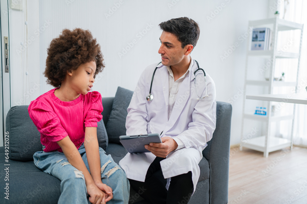 Hospitalized children with sitting in chairs while doctor checking his pulse. Doctor examining senior male patient in hospital room.