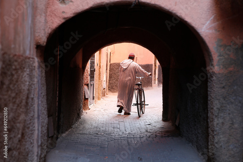 Man with bike in Marrakesh medina (old city), Morocco. photo