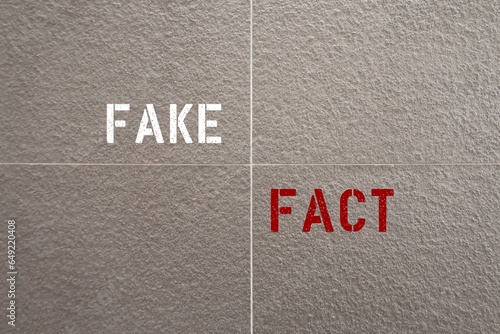 Foto Wall with text FAKE and FACT,concept of awareness before spreading made-up stuff