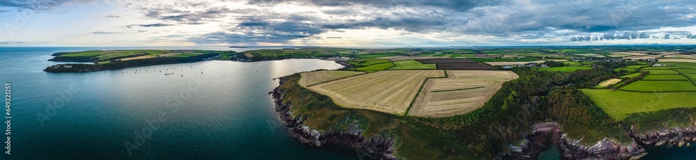 Panorama of Sunset over Fields and Farms from a drone, Monk Haven Beach, Pembrokeshire Coast Path, Haverfordwest, Wales, England