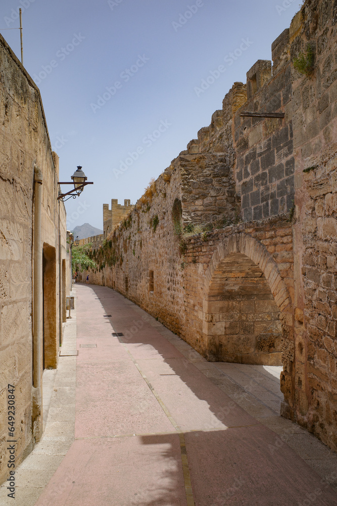 Alcuda, Spain - 9 July, 2023: Roman city walls in the old town of Alcudia, Mallorca